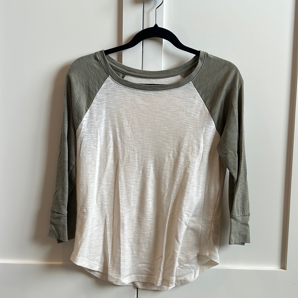 3/4 sleeve warm white and olive green shirt.